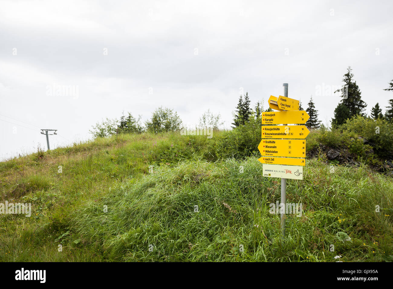 Yellow sign indicating hiking trails at Zillertal, Austria Stock Photo