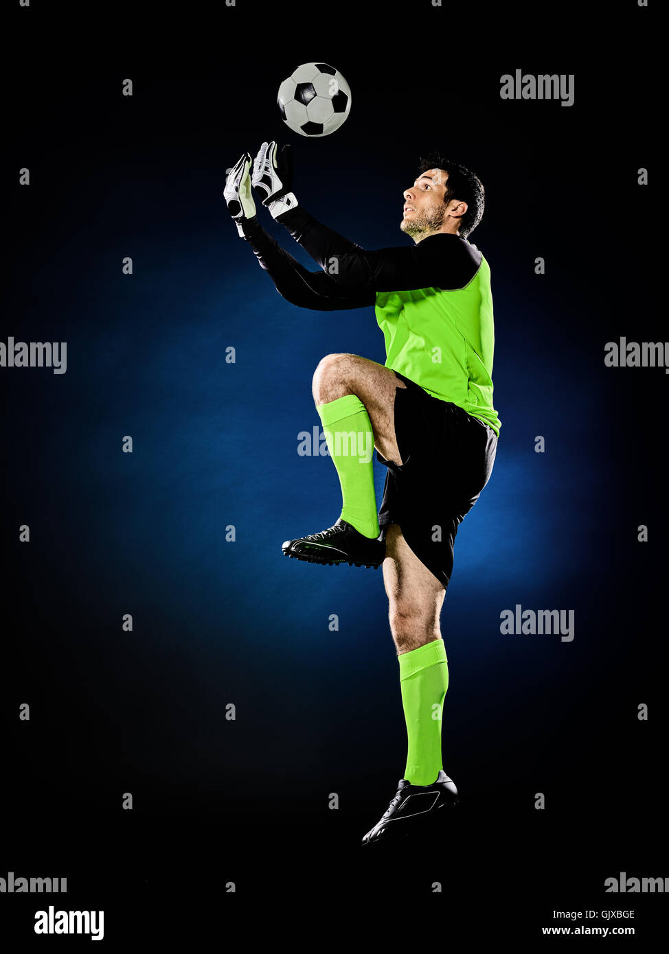 one caucasian goalkeeper soccer man isolated on black background Stock