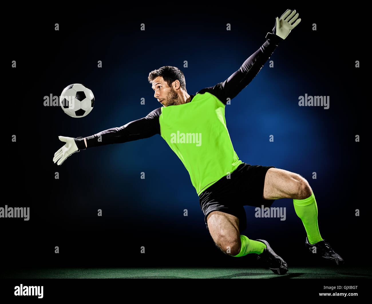 one caucasian goalkeeper soccer man isolated on black background Stock
