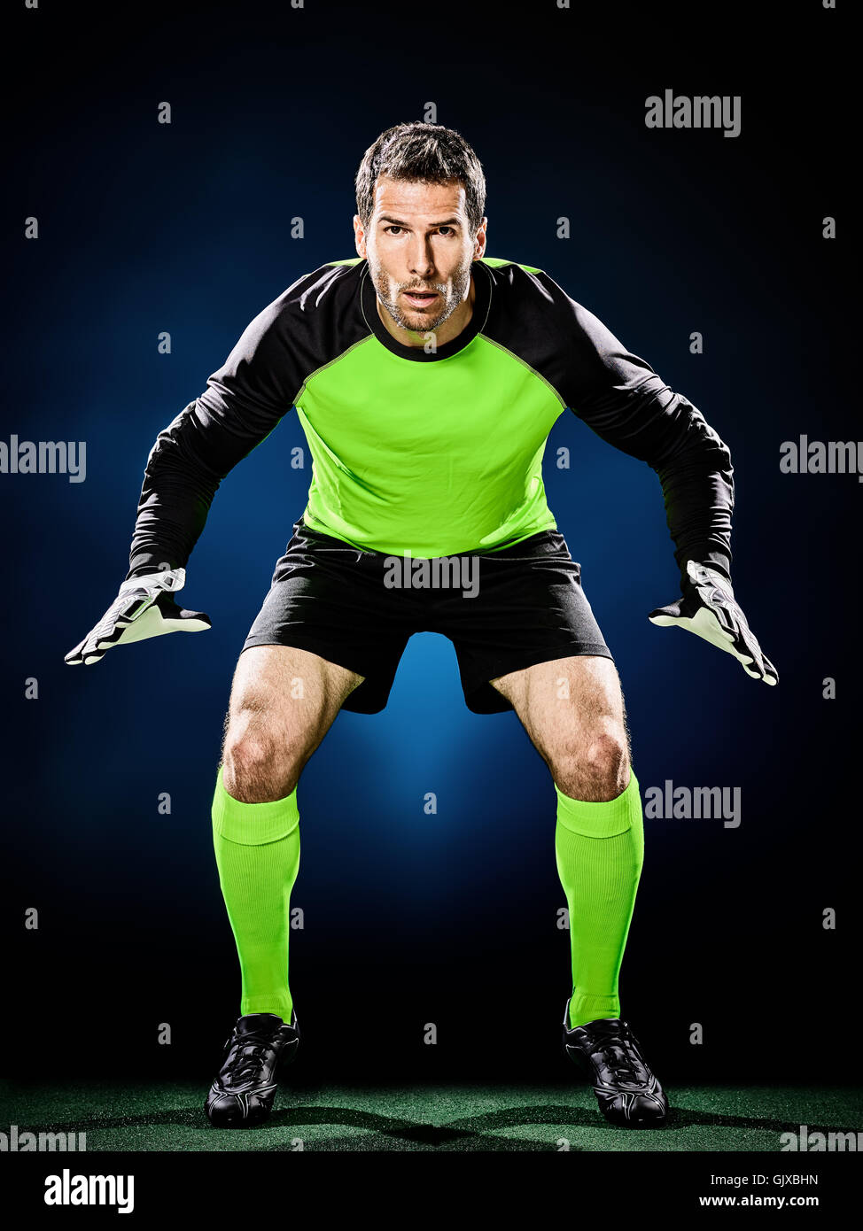 one caucasian goalkeeper soccer man isolated on black background Stock