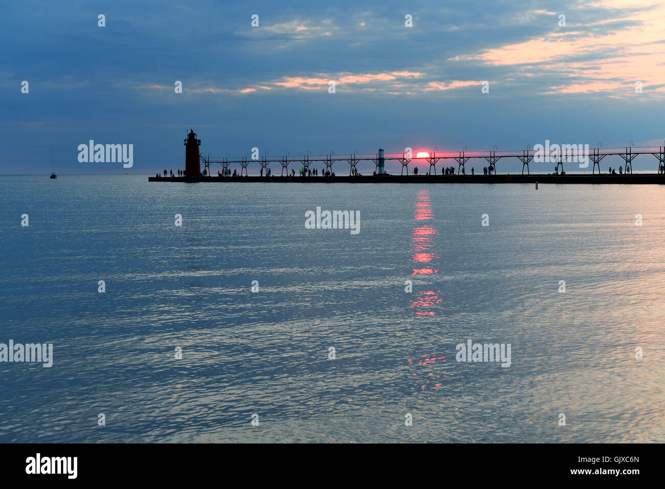 Lighthouse and pier in South Haven Michigan at sunset Stock Photo
