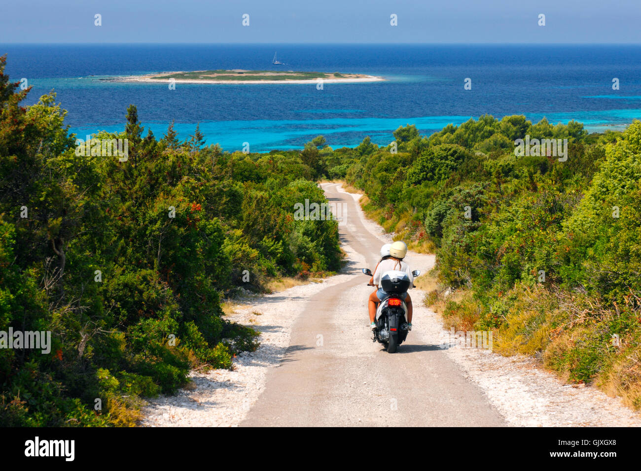 Tourists ride scooter on the road to the beach on Dugi otok Stock Photo -  Alamy