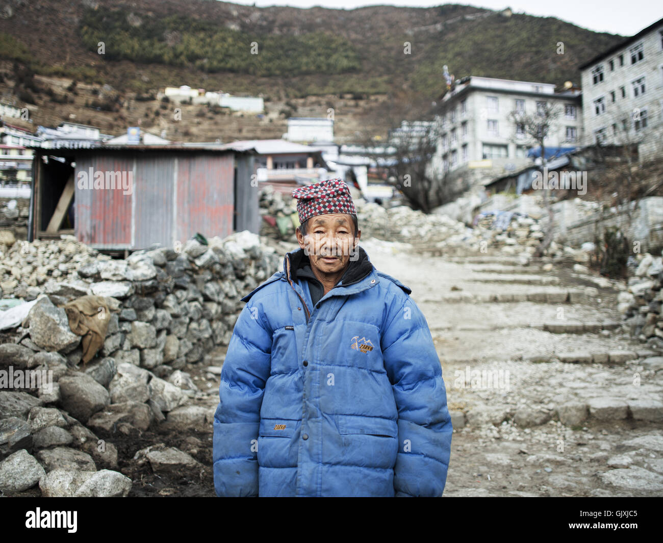 A Nepalese man stands outside his village in Namche, Nepal Stock Photo