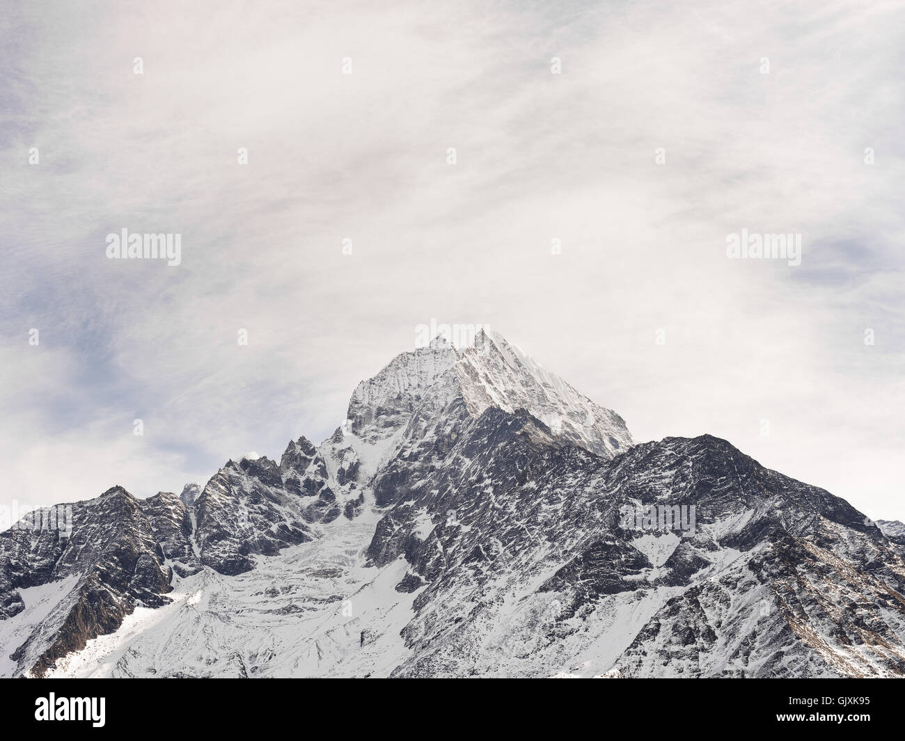 Snow covered peak of a jagged Himalayan mountain in Nepal's Everest Base Camp Stock Photo