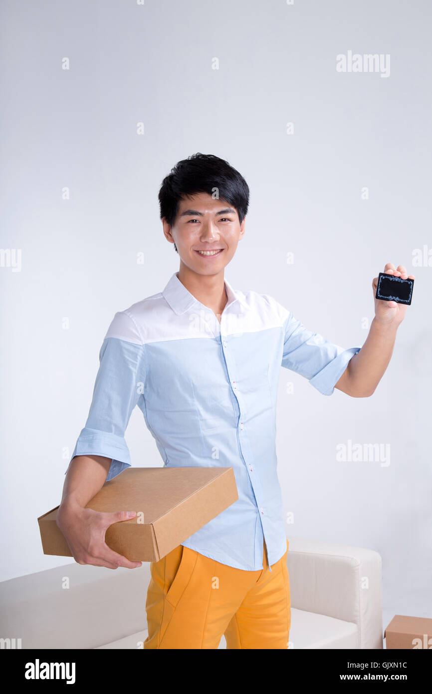Studio shot Young man show merchandise Stock Photo - Alamy