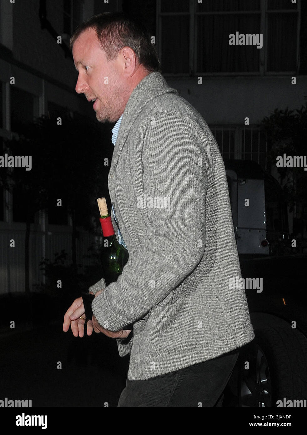 Guy Ritchie seen arriving at Madonnas London home with a bottle of wine ...