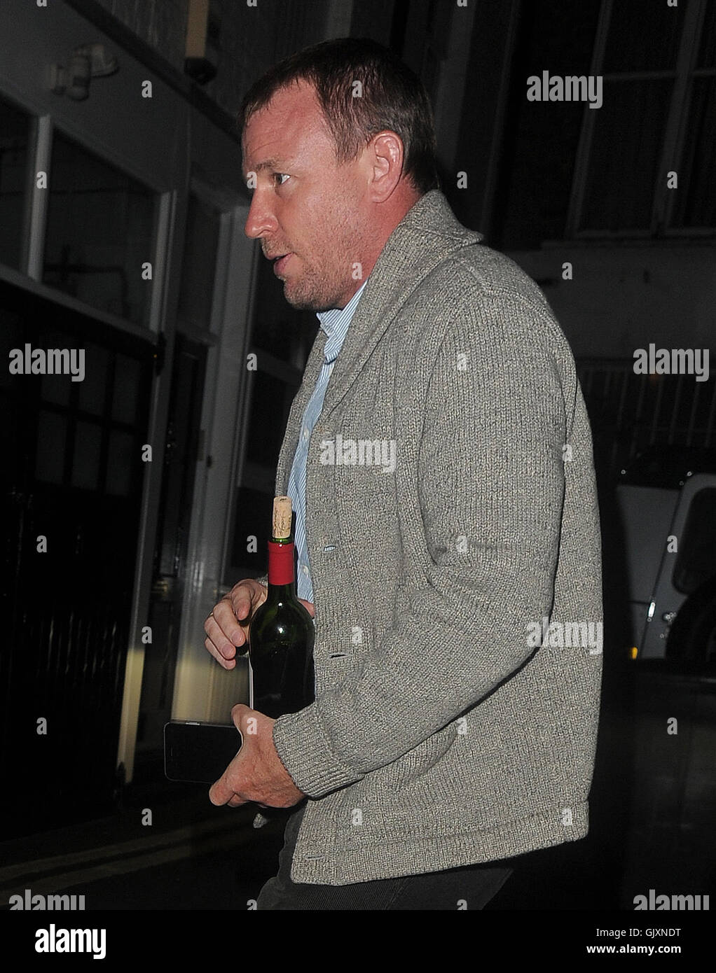 Guy Ritchie seen arriving at Madonnas London home with a bottle of wine ...