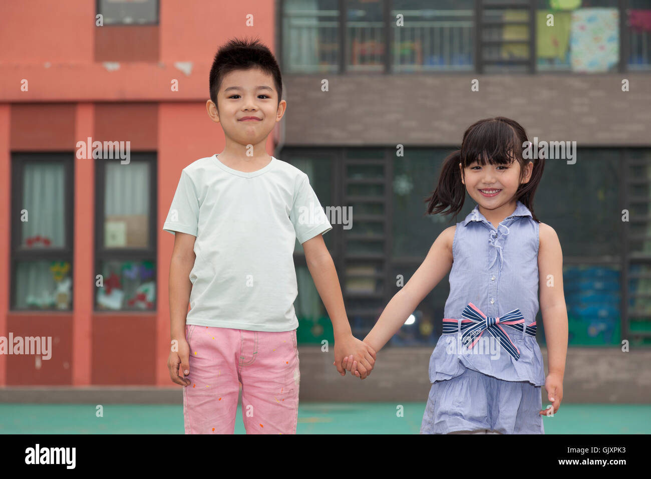 Children in kindergarten hand in hand Stock Photo - Alamy