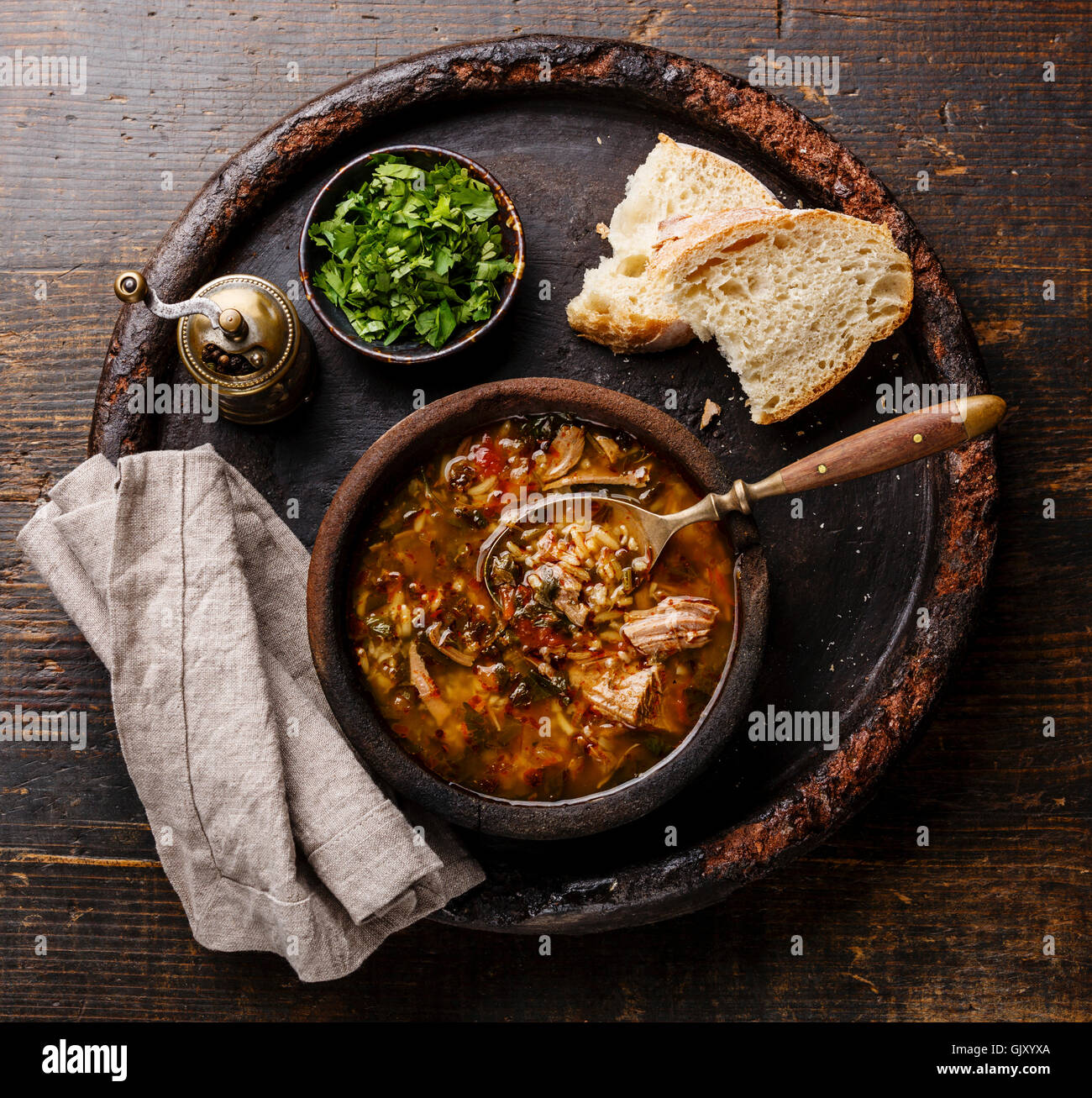 Traditional Georgian soup Kharcho with meat and rice on wooden background Stock Photo