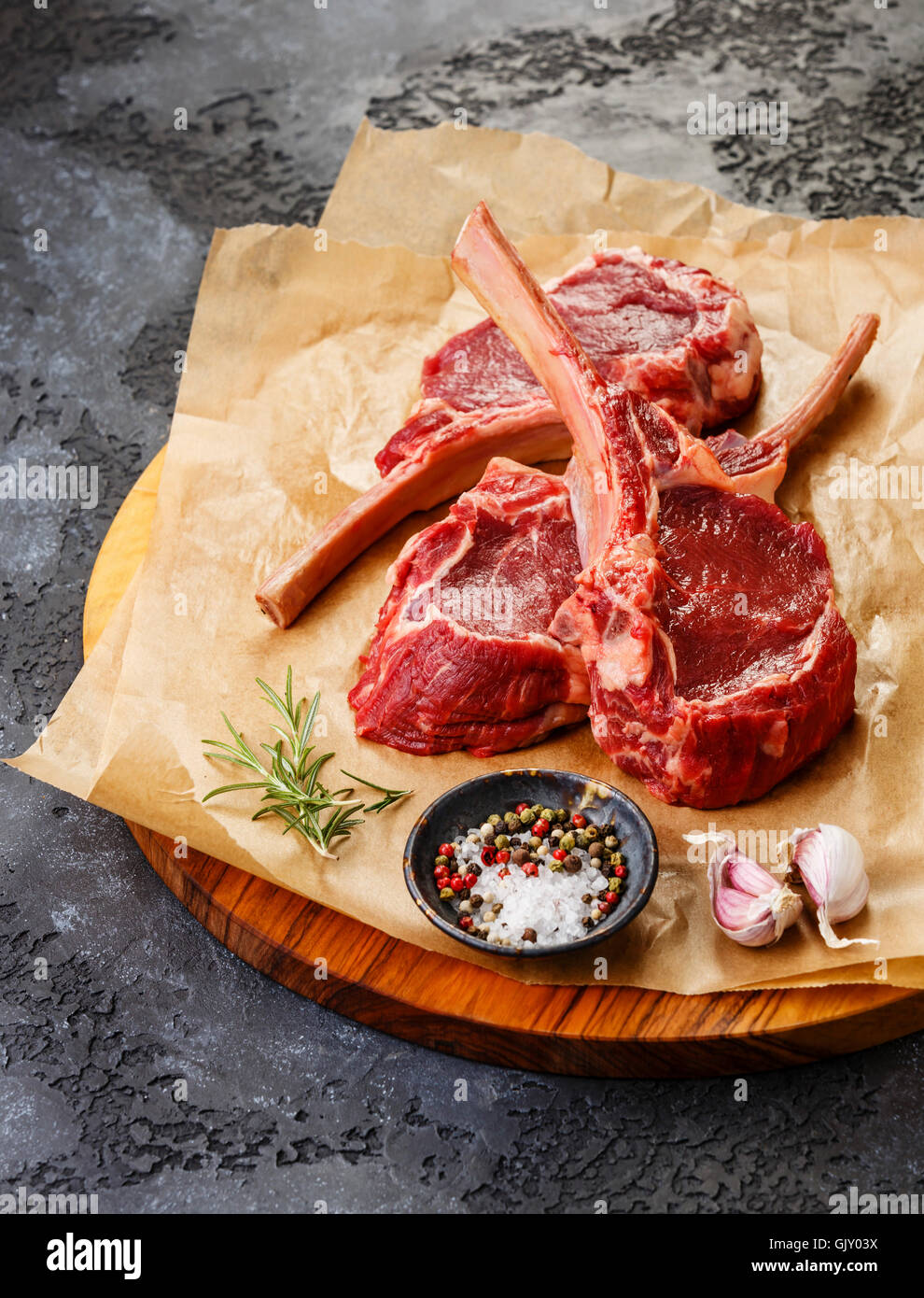 Raw fresh meat Veal ribs Steak on bone and spices on dark background Stock Photo