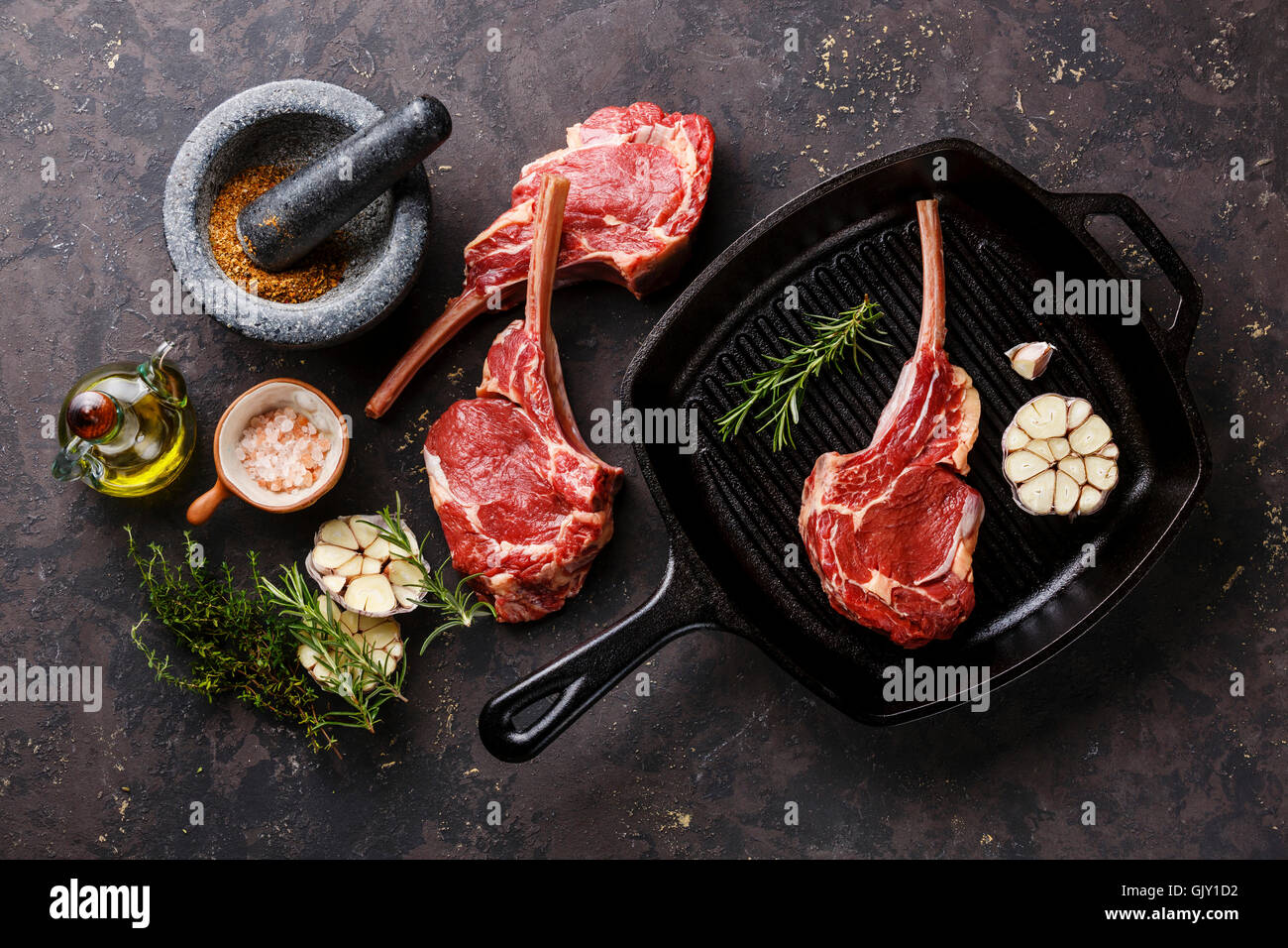 Raw fresh meat Veal ribs with ingredients on frying cast iron Grill pan Stock Photo