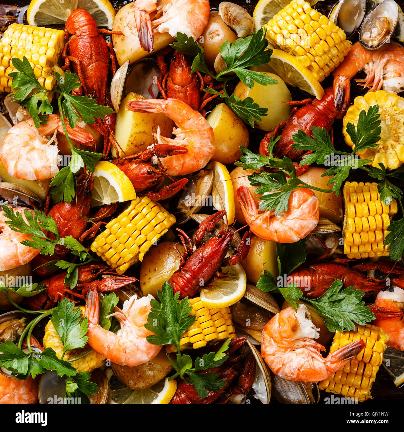 Clambake Seafood boil with Corn on the cob, Potatoes, Prawns, Crayfish and Clams Stock Photo