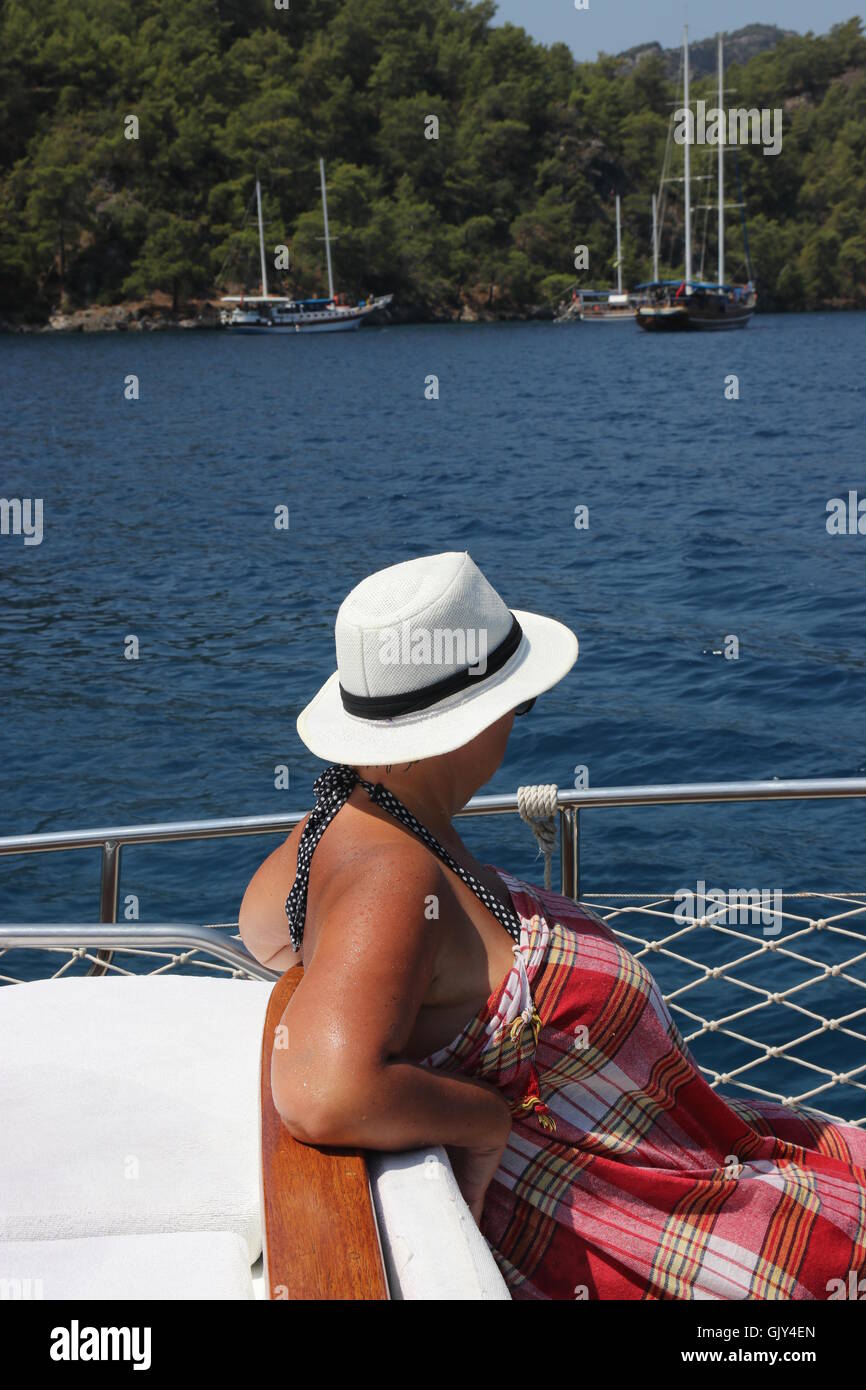 An english lady relaxing while on a boat trip around the bays at fethiye in turkey Stock Photo