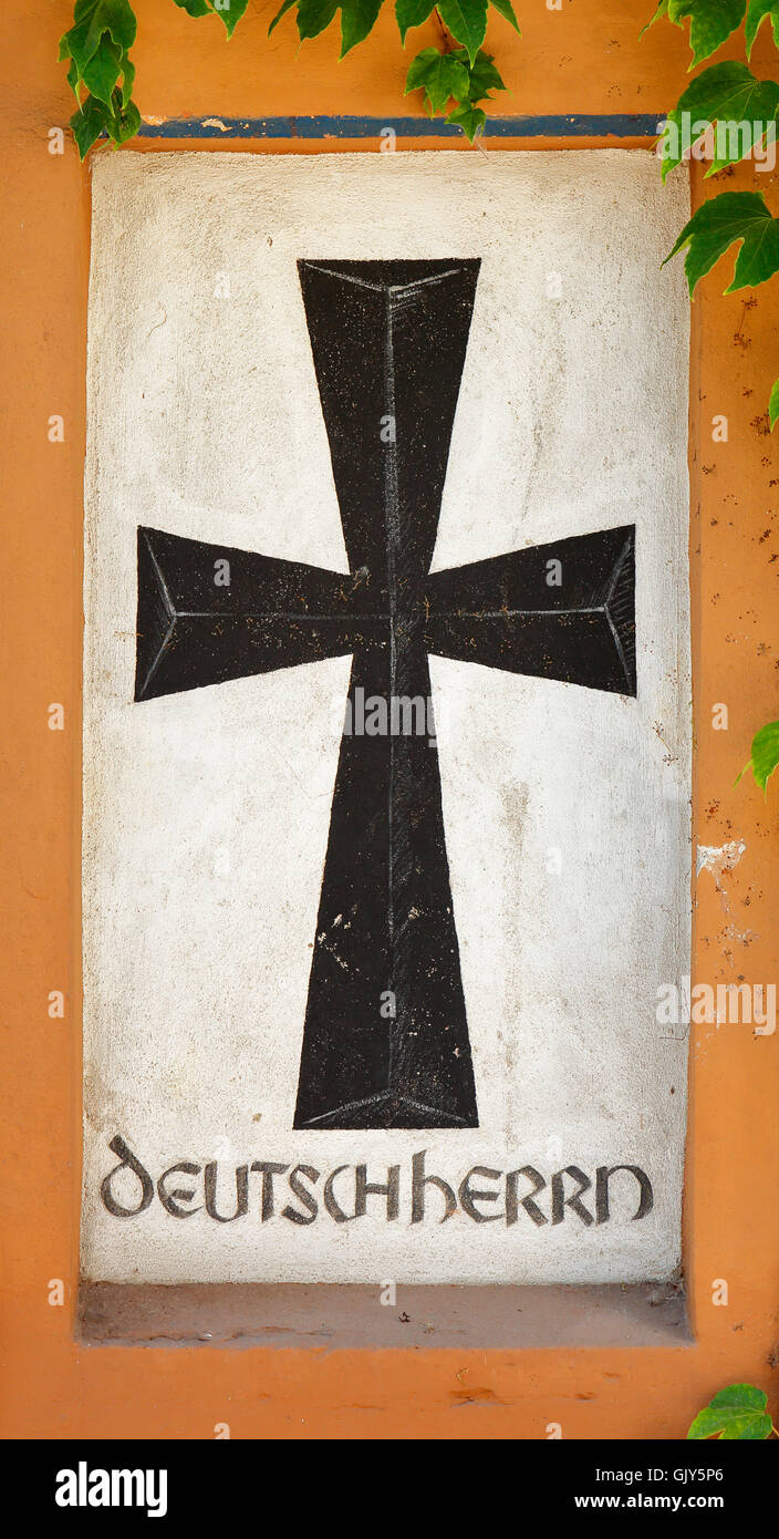 D-Worms, Rhine, Upper Rhine, Rhenish Hesse, Rhine-Neckar area, Rhine-Main district, Rhineland-Palatinate, D-Worms-Ibersheim, Ibersheim village, heraldic figure German Order, cross patty at the farm Fass in the Menno Simons Strasse Stock Photo