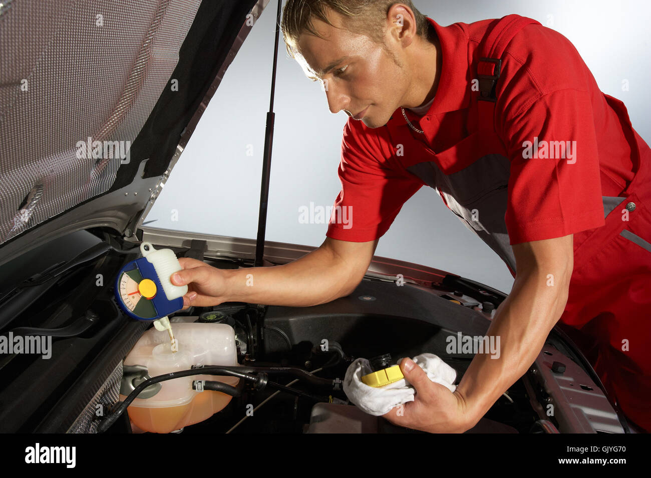 car mechanic checking cooling water Stock Photo Alamy