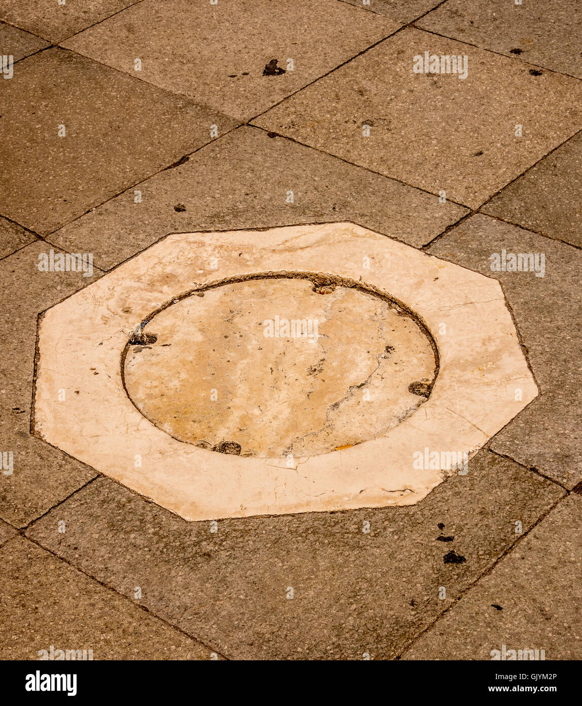 Ornate marble octagonal drain in St mark's square, Venice. Italy. Stock Photo