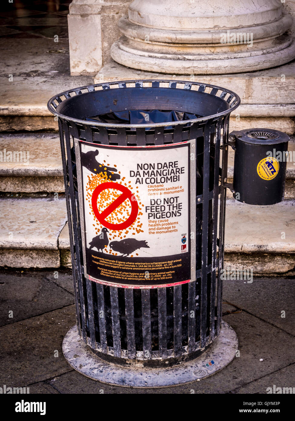 Rubbish bin in Piazzetta San Marco with Do not Feed Pigeons sign on it. Venice, Italy. Stock Photo
