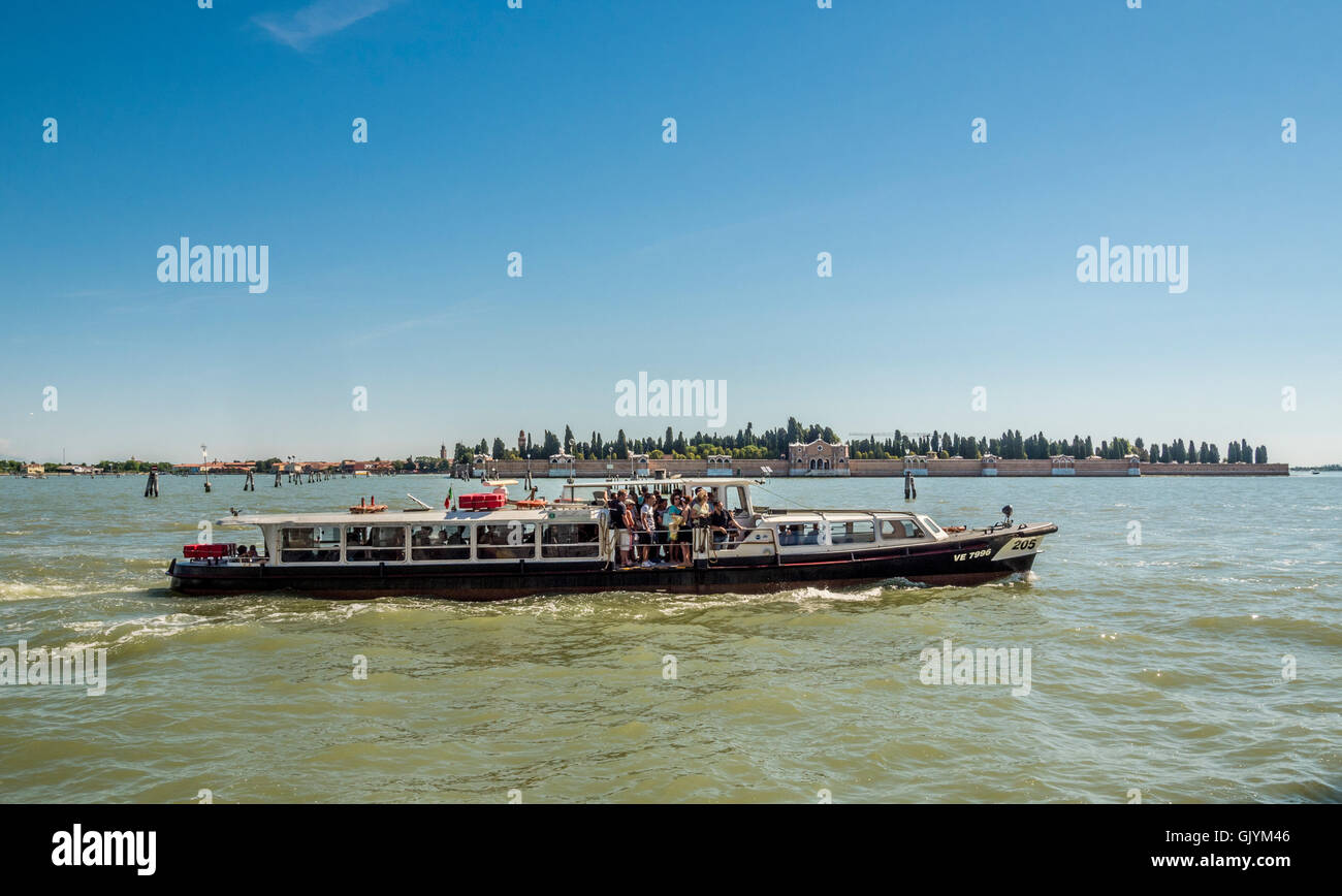 Vaporetto or water bus with the cemetery island of San Michele in the distance. Venice, Italy. Stock Photo