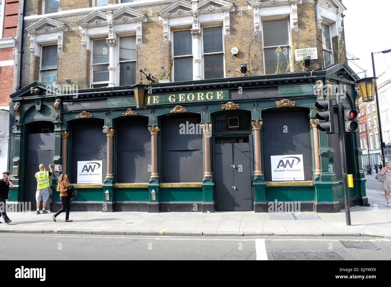 A general view of the George, a Victorian style pub in central London, closed down and boarded-up. Stock Photo