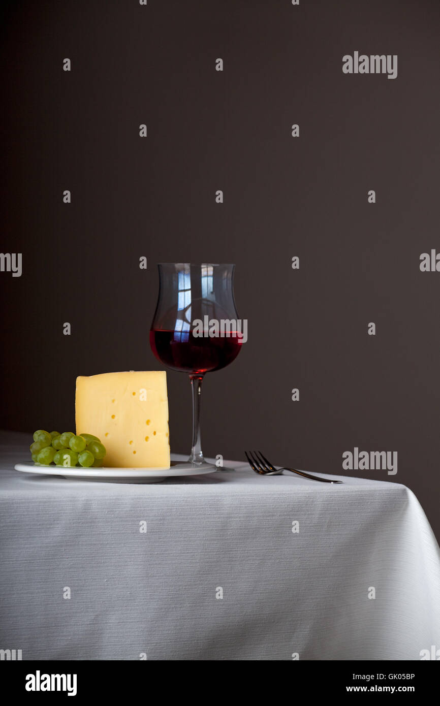 piece of cheese,a bunch of grapes and red wine Stock Photo