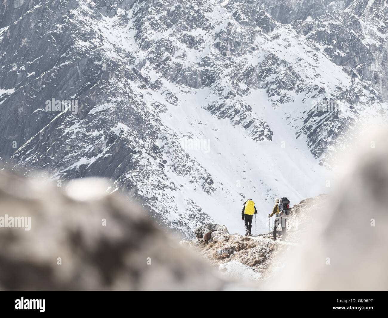 Hikers make their way through Nepal's Himalayas as they backpack Everest Base Camp Stock Photo