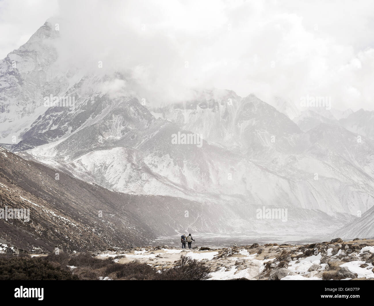 Hikers face the snowy Himalayas near Pheriche, Nepal on their journey of Everest Base Camp Stock Photo