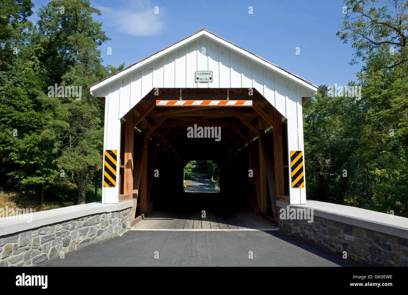 Covered bridge in Lancaster County, PA. A covered bridge is a timber-truss bridge with a roof and siding. Stock Photo