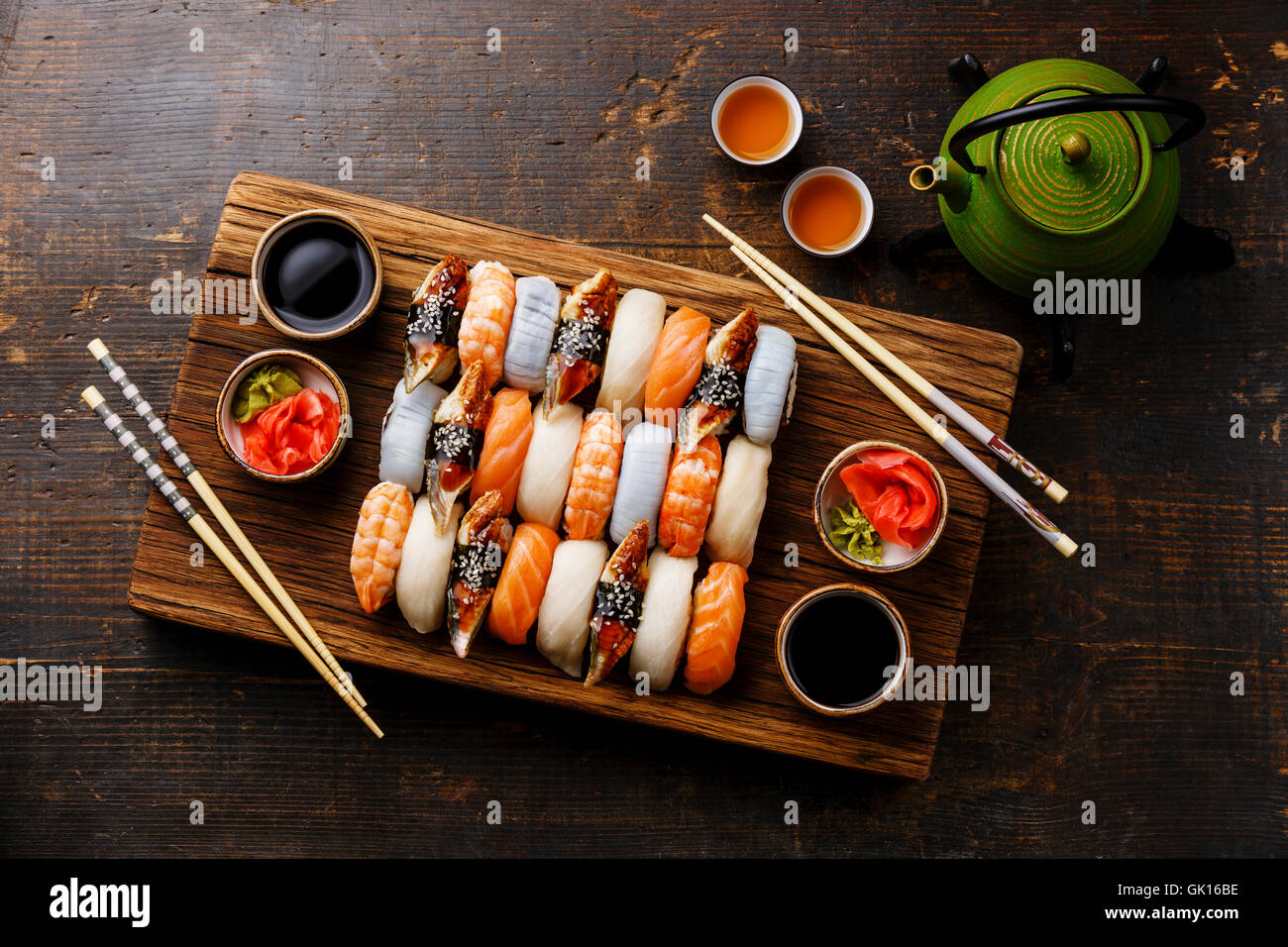 Nigiri sushi set for two on wooden serving board block and green tea Stock Photo