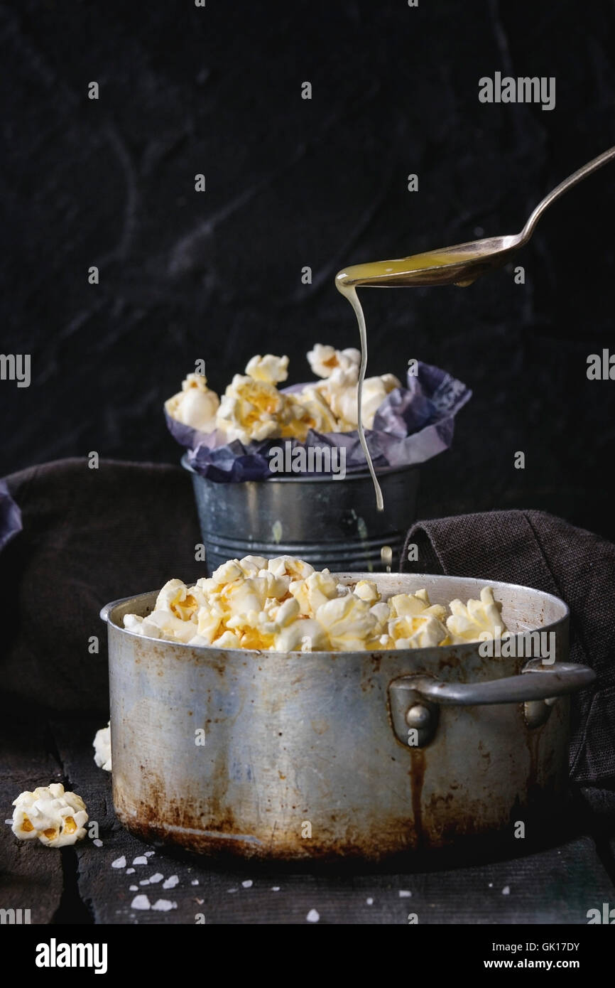 Prepared buttered popcorn served with sea salt in small buckets and