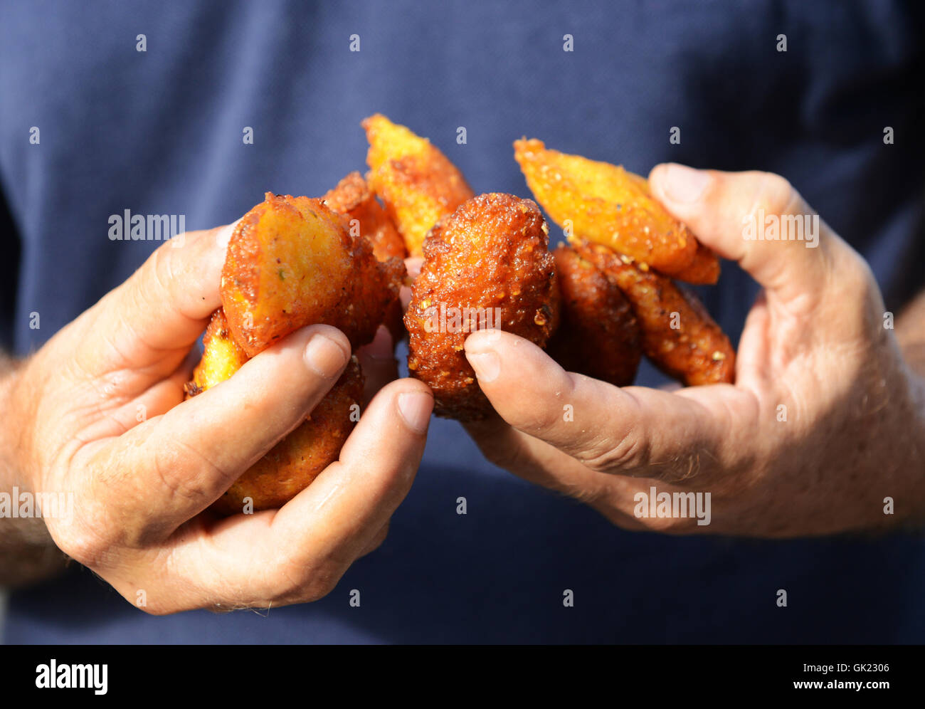 Holding fresh corn fritters (Frituras de Maiz) in Pinar Del Rio,Cuba. Stock Photo