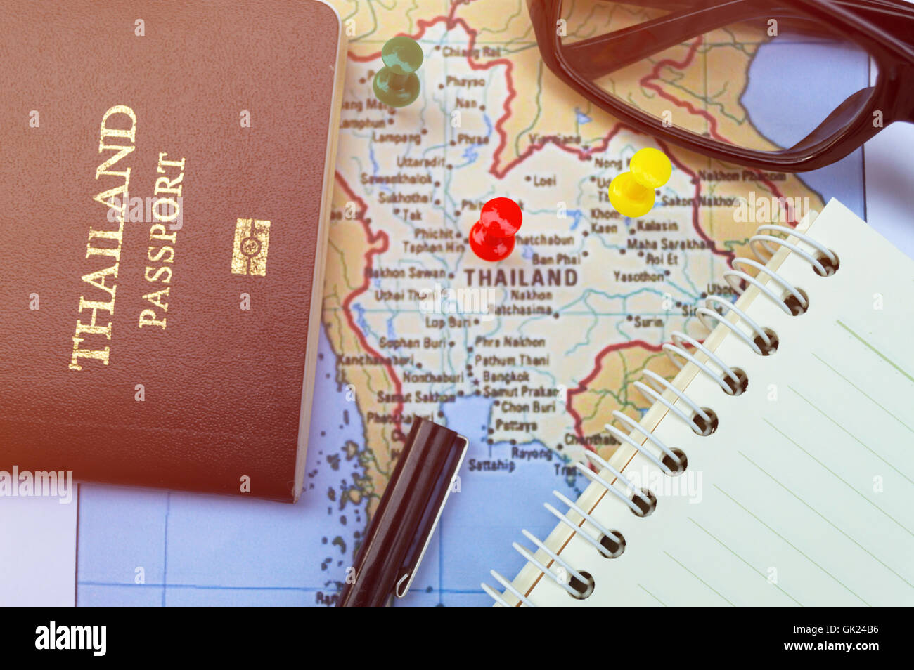 Go on an adventure! The map and the passport on a wooden table. Top view. Stock Photo