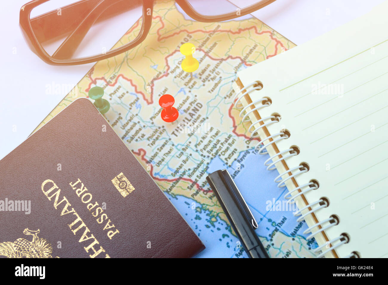 Go on an adventure! The map and the passport on a wooden table. Top view. Stock Photo