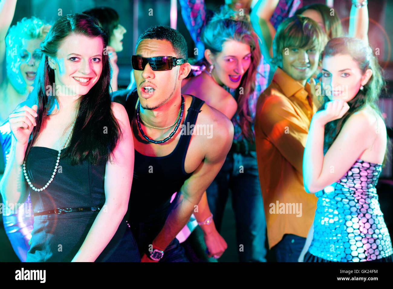 friends dancing in disco or club Stock Photo
