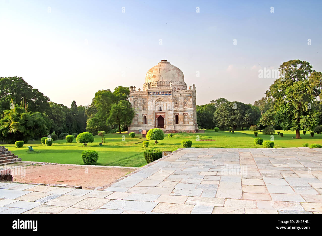 Lodi Gardens on the sunset. Islamic Tomb (Seesh Gumbad) set in landscaped gardens. 15th Century AD. New Delhi, India Stock Photo