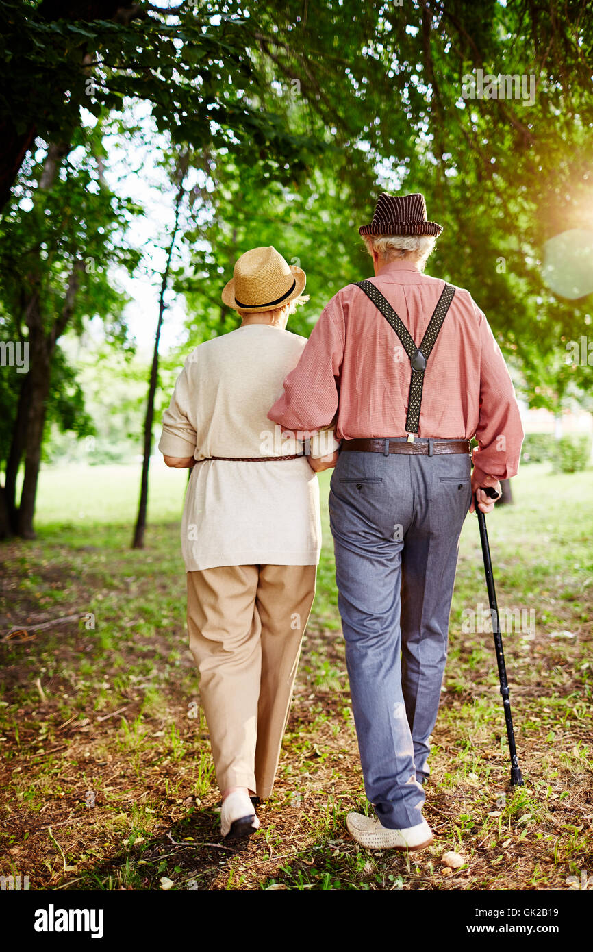 Senior woman walking in park hi-res stock photography and images - Alamy