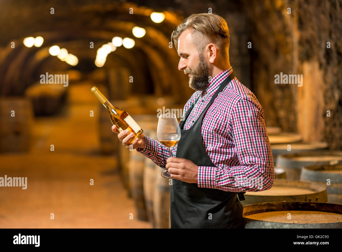 Sommelier with wine bottle in cellar Stock Photo