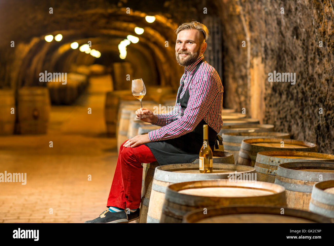 Portrait of a sommelier in the wine cellar Stock Photo