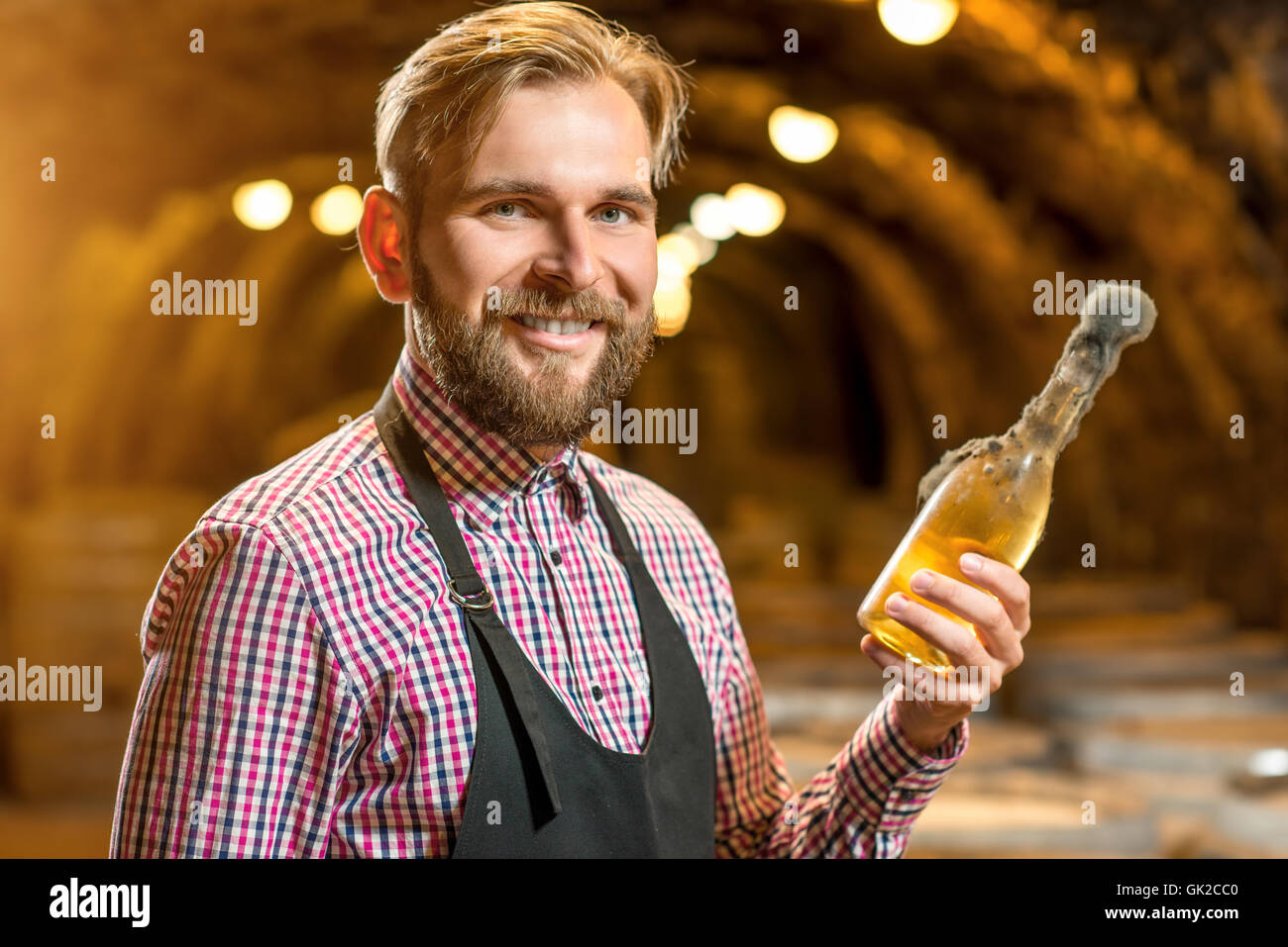sommelier with wine bottle in a cellar Stock Photo Alamy