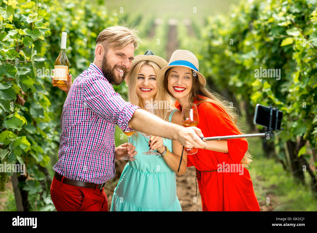 Three friends on the vineyard Stock Photo