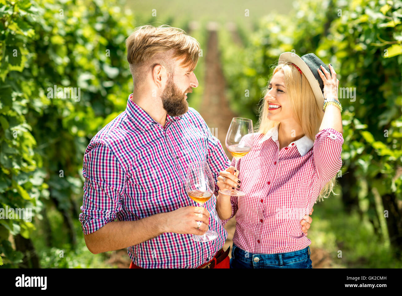Couple having fun with glasses of wine on the vineyard Stock Photo