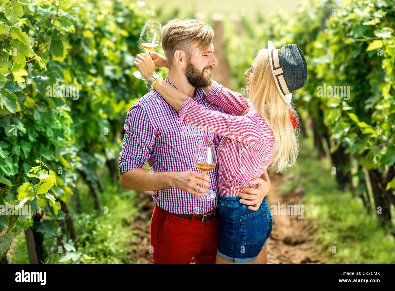 Couple having fun with glasses of wine on the vineyard Stock Photo