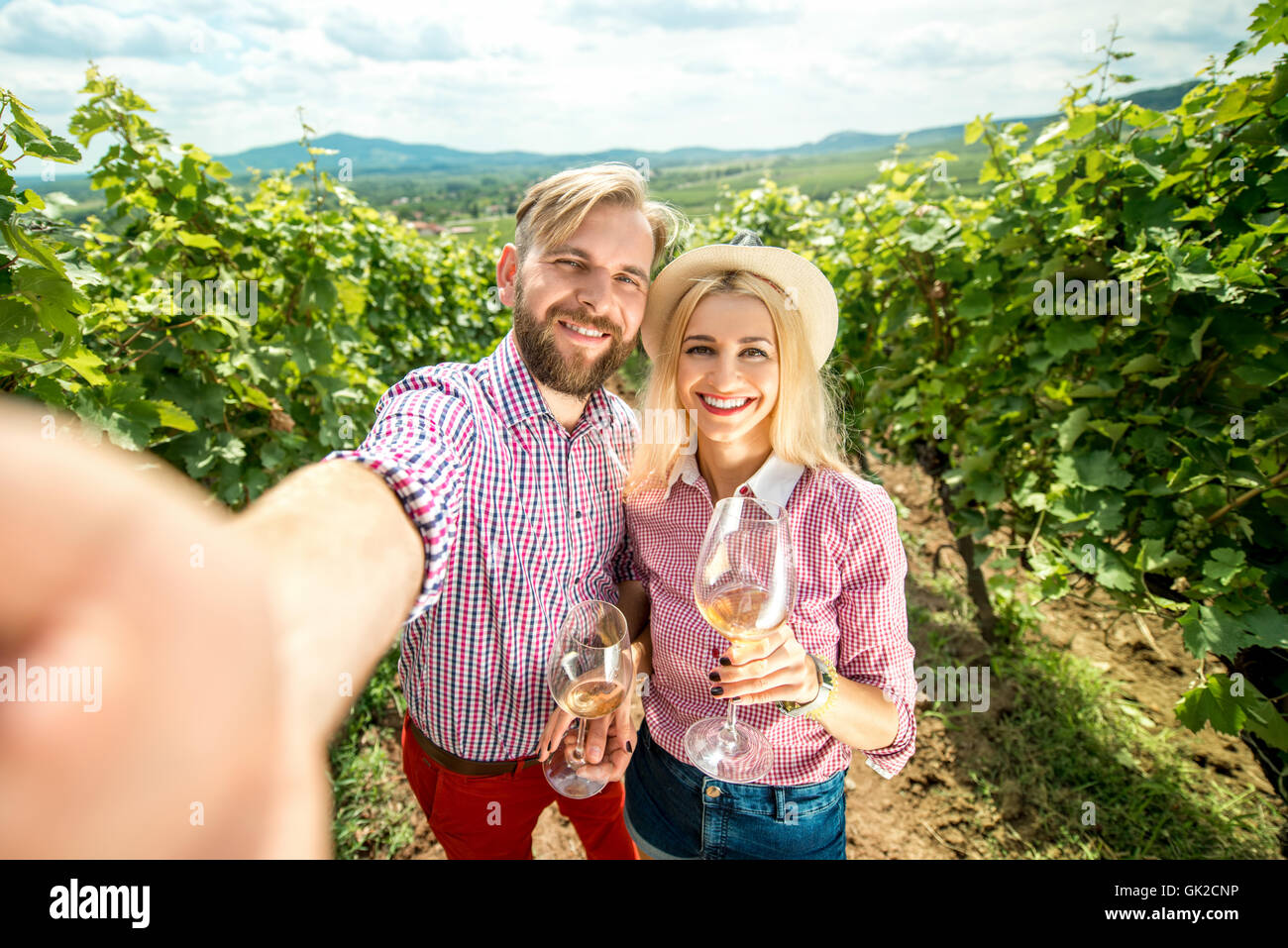 Couple with glasses of wine on the vineyard Stock Photo