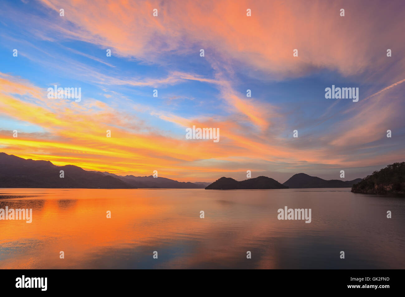 Sunset at lake with vivid sky Stock Photo
