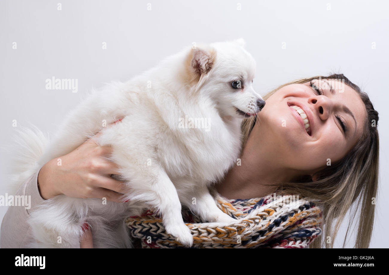 Happy girl with her little dog in studio Stock Photo - Alamy