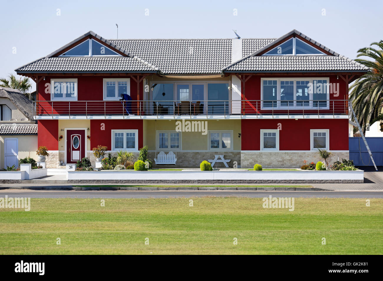 Red Beach House in Walvis Bay, Namibia Modern Affluent House on Beach Front Living architecture double storey home cleaner Stock Photo