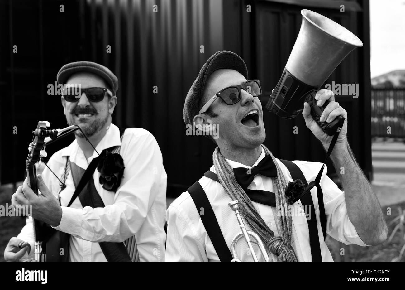 Street Performers, buskers, musicians lauging and putting on a show with megaphone, banjo player, dixie two men Stock Photo