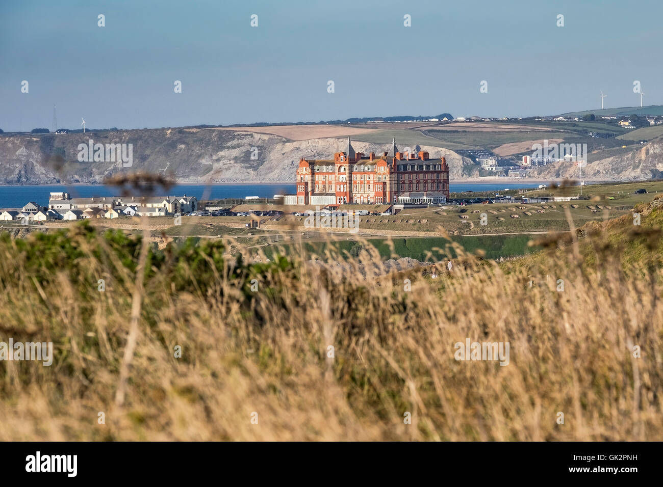 A distant view of the Headland Hotel seen from East Pentire in Newquay, Cornwall Stock Photo