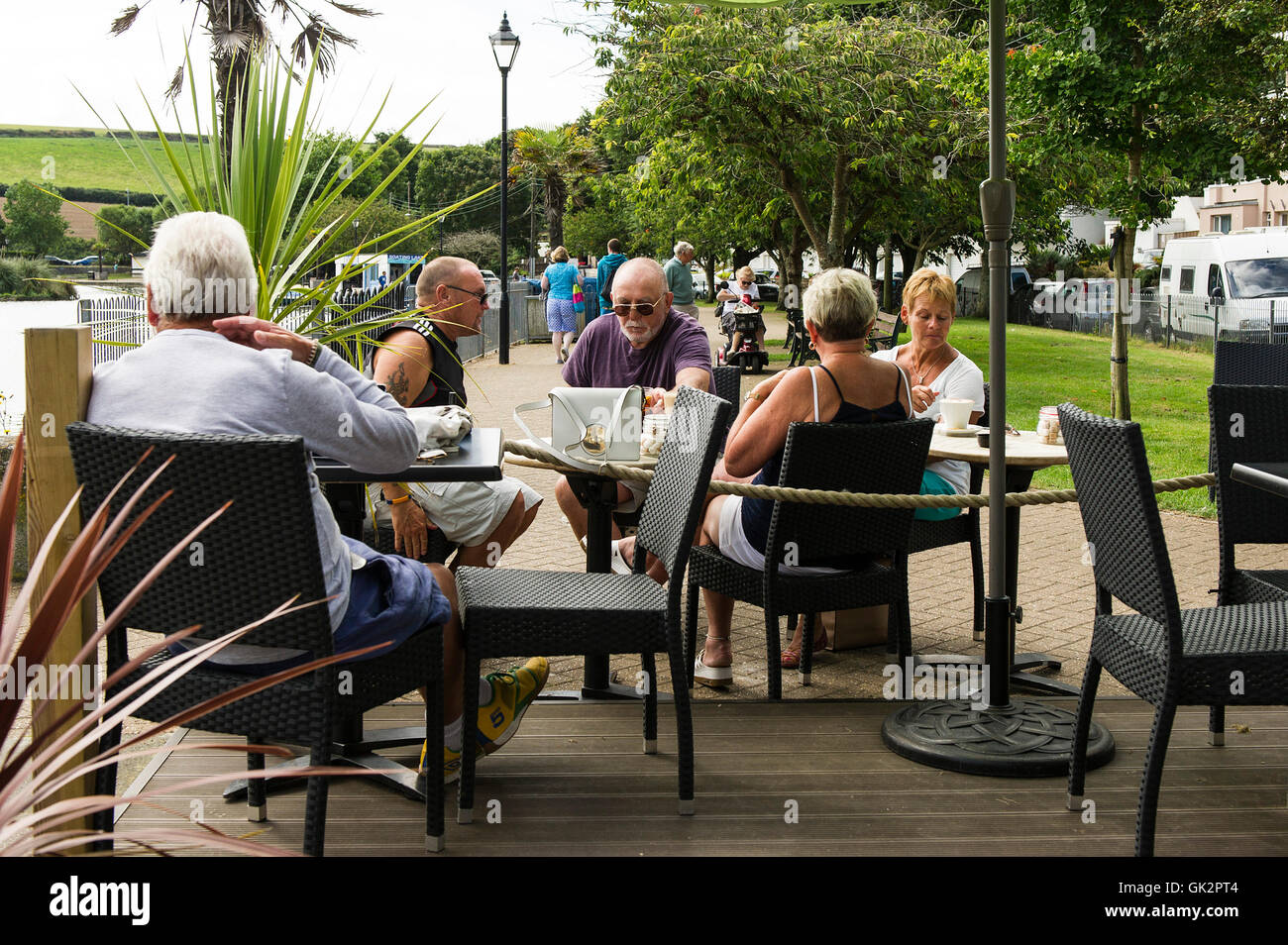 People relax over a coffee in Trenance Gardens in Newquay, Cornwall. Stock Photo