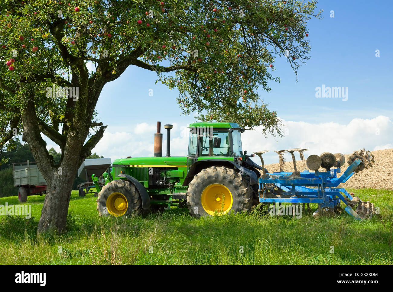 tractor blends in beautiful rural landscape Stock Photo