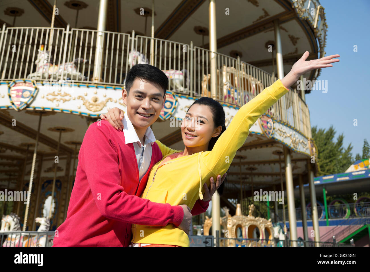 Young couple went to the amusement park Stock Photo - Alamy